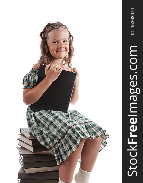 Little girl sitting on stacked books