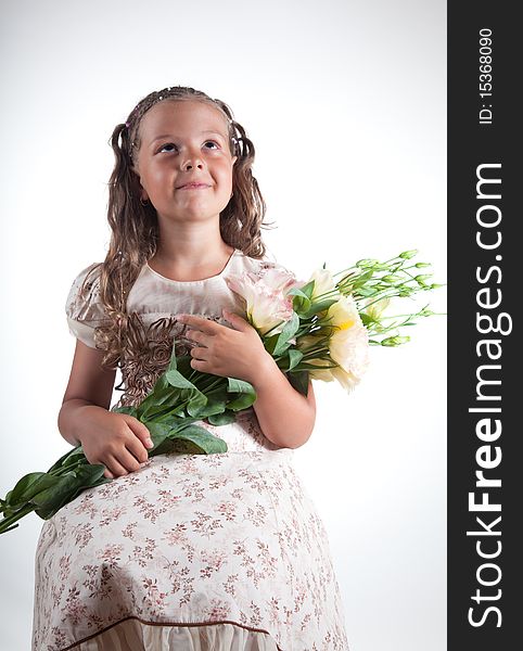 Little girl with flowers, studio shot