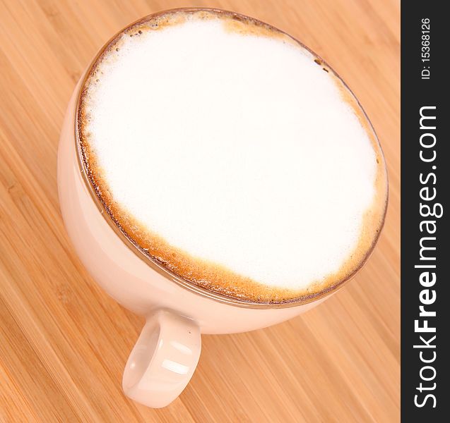 Cup of coffee latte on a wooden background