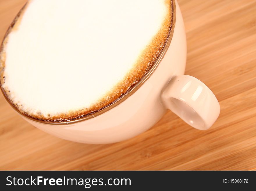 Cup of coffee latte on a wooden background