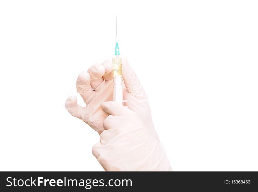 Hand in glove holding syringe and needle. Hand in glove holding syringe and needle