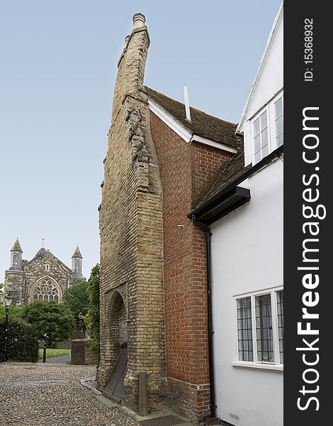 View of a very old brick house with a very bent chimney. View of a very old brick house with a very bent chimney