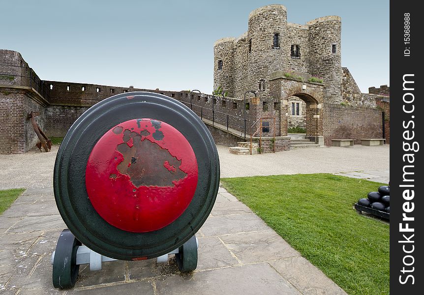 Close up view of an old canon, with a castle in the background. Image captured with an ultra wide angle lens, accentuating the proximity of the canon and distance of the castle. Close up view of an old canon, with a castle in the background. Image captured with an ultra wide angle lens, accentuating the proximity of the canon and distance of the castle