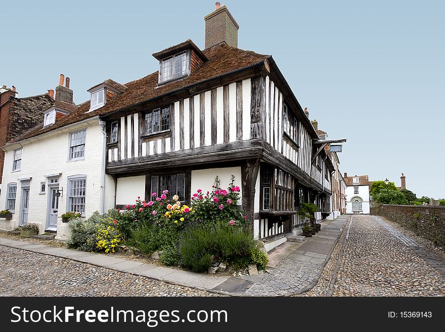 View of an old tudor house with a colourful flowerbed. View of an old tudor house with a colourful flowerbed