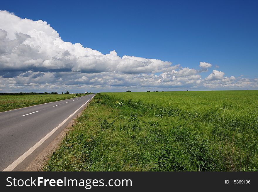 Empty road in a green field. Empty road in a green field