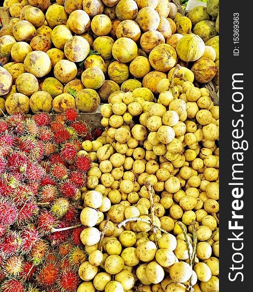 Close up of Rambutan, Santol, and Lanzones fruits in an Asian market