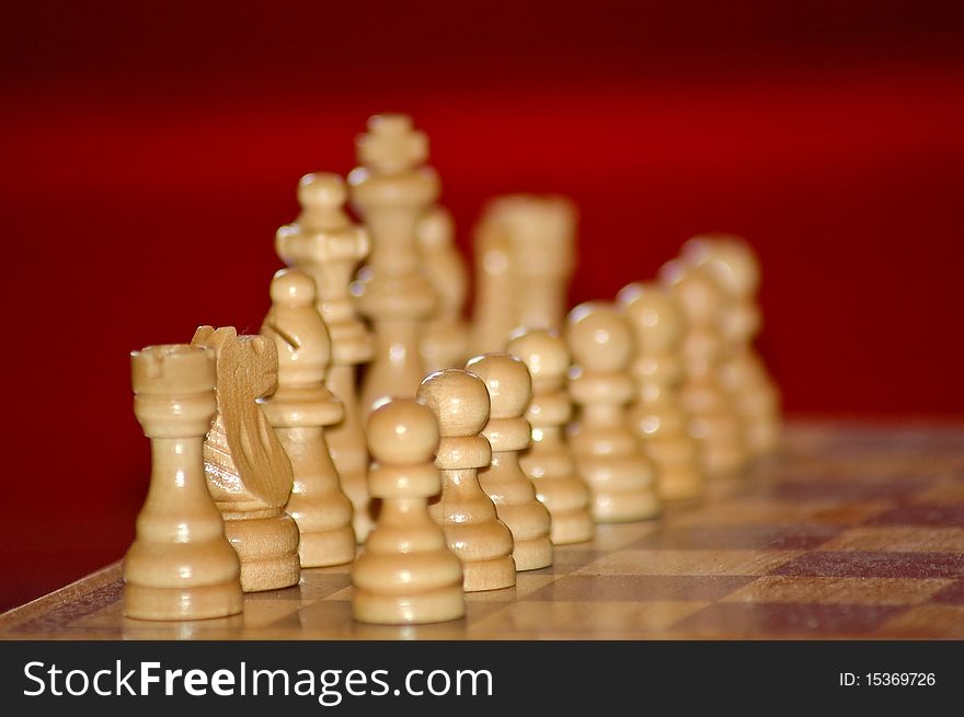Chess pieces standing on a board. Chess pieces standing on a board