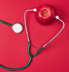 Ripe Apple And Green Medical Stethoscope Royalty Free Stock Image