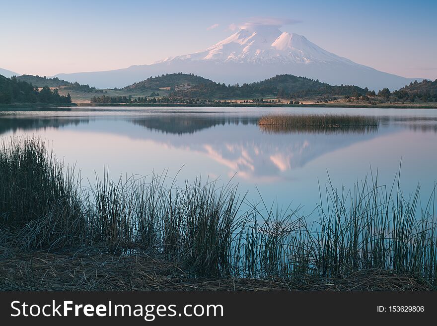 A Reflection Of Snow Capped Mount Shasta In A Clear Water In Lake  At Sunrise In California State, USA.  Mount Shasta Is A Volcano