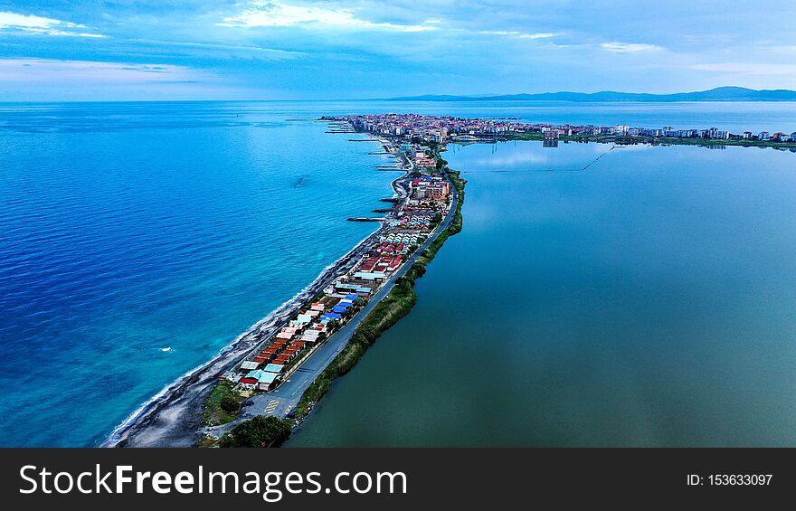 Aerial Shot Of Houses On Narrow Shore In The Middle Of The Sea