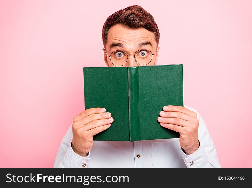 Close up photo portrait of comic cheerful enthusiastic with big staring looking eyes holding paper green book and