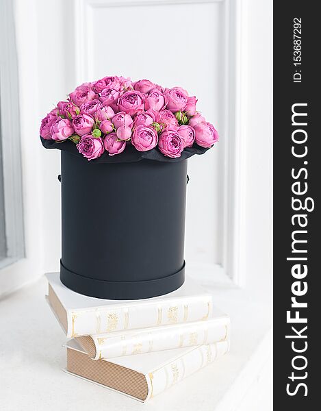 Beautiful Bouquet of flowers in a round hat box on a table or chair