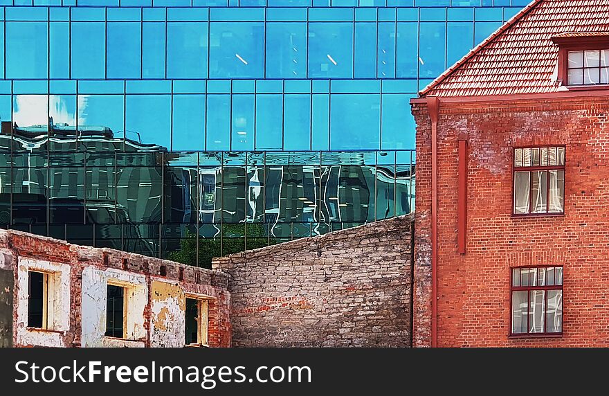Windows reflection modern new building and old vintage house blue  glass and stone of front house wall  red heart