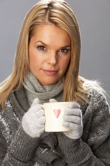 Young Woman Drinking Hot Drink Wearing Knitwear Stock Photos Young Woman Drinking Hot Drink Wearing Knitwear Stock Photos