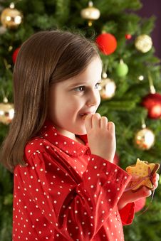 Girl Eating Star Shaped Cookie In Front Of Tree Stock Photography Girl Eating Star Shaped Cookie In Front Of Tree Stock Photography