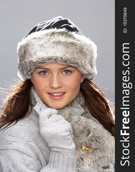 Studio Portrait Of Young Woman Wearing Fur Hat And Wrap