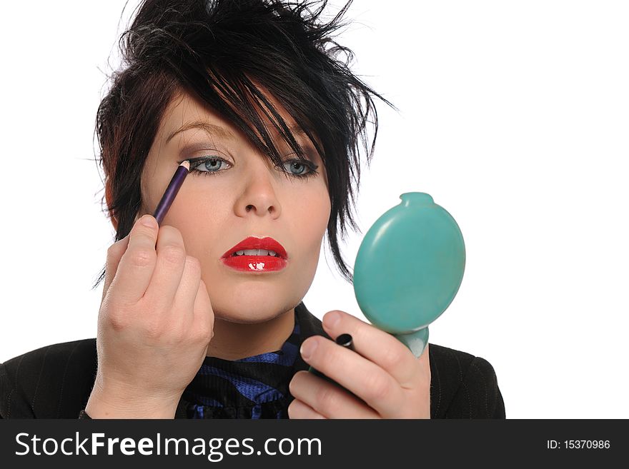 Young girl applying make up isolateed o a white background