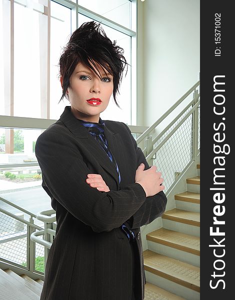 Young brunette businesswoman with crossed arms