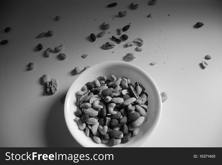 A bowl of nuts scattered. A bowl of nuts scattered