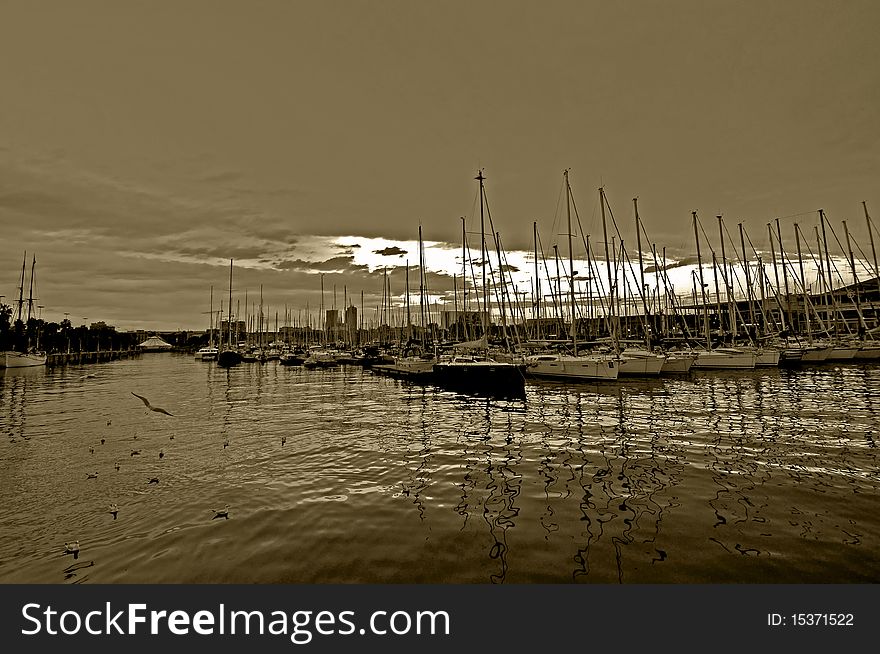 A row of yachts at Port Vell in Barcelona. A row of yachts at Port Vell in Barcelona.