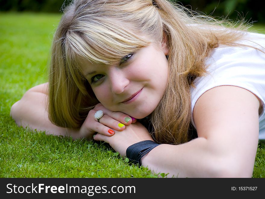 Girl smiling and looking happy on a lawn. Girl smiling and looking happy on a lawn