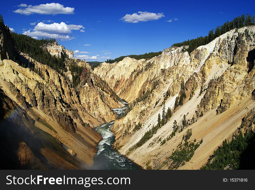 Grand Canyon of the Yellowstone National Park. Mountain landscape with blue sky and clouds. Grand Canyon of the Yellowstone National Park. Mountain landscape with blue sky and clouds.