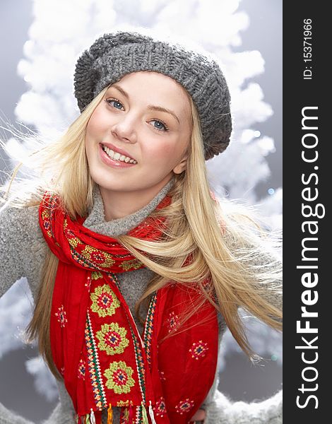 Fashionable Teenage Girl Wearing Cap And Knitwear In Studio In Front Of Christmas Tree. Fashionable Teenage Girl Wearing Cap And Knitwear In Studio In Front Of Christmas Tree