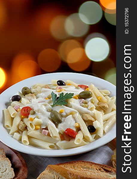Italian cuisine, penne with white sauce and green olives