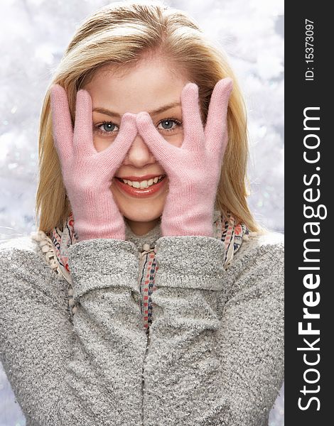 Fashionable Teenage Girl Wearing Cap And Knitwear In Studio In Front Of Christmas Tree