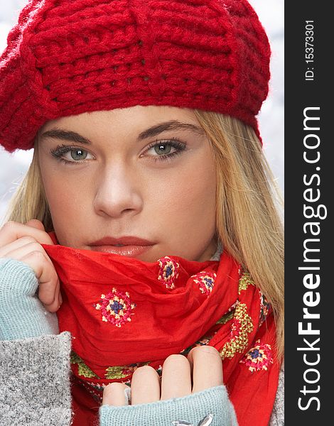 Fashionable Teenage Girl Wearing Cap And Knitwear In Studio In Front Of Christmas Tree