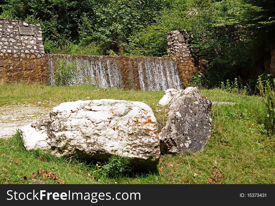 Mountain relief: waterfall and stones in the forest