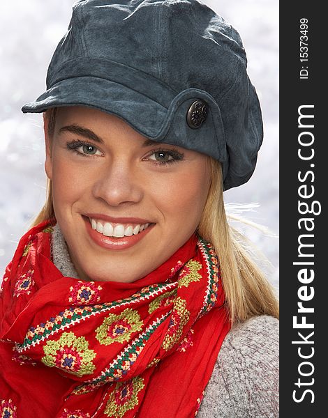 Fashionable Teenage Girl Wearing Cap And Knitwear In Studio In Front Of Christmas Tree. Fashionable Teenage Girl Wearing Cap And Knitwear In Studio In Front Of Christmas Tree