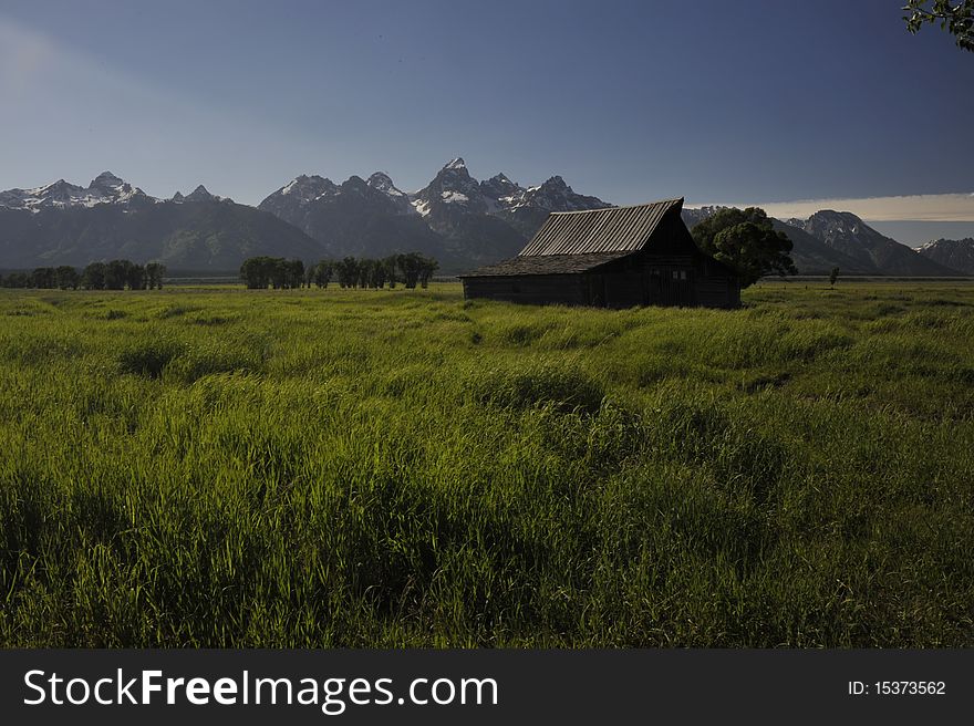The Moulton cabin sets in front of the Teton landscape.
