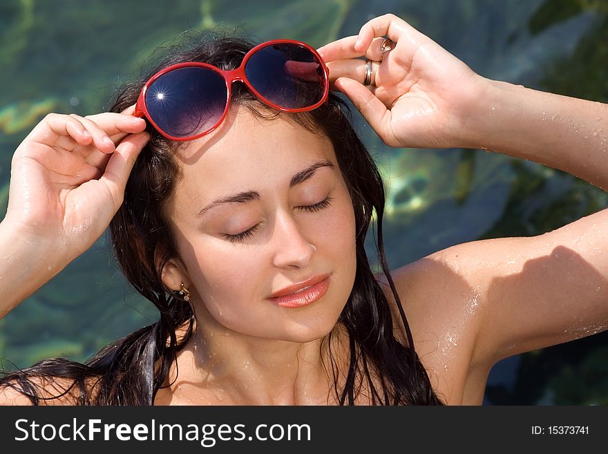 Young girl with red sunglasses relaxing near the sea. Young girl with red sunglasses relaxing near the sea