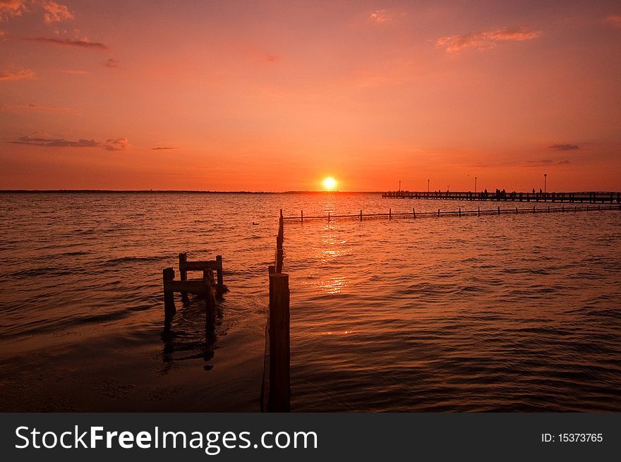 Sunset over water and dock. Sunset over water and dock