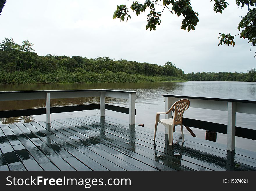 A Porch overlooking a river on a rainy day. A Porch overlooking a river on a rainy day.