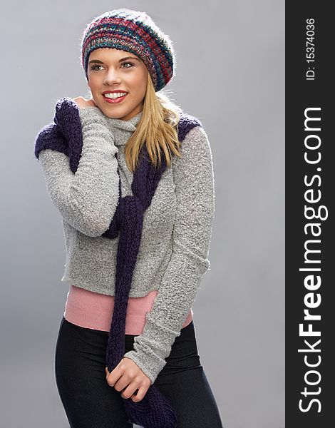 Teenage Girl Wearing Warm Winter Clothes In Studio Smiling