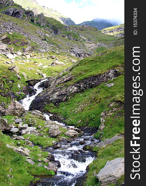 Beautiful landscape with rocky waterfall at high altitude