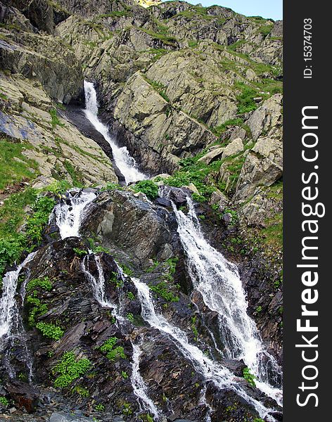 Rocky waterfall on a little river at high altitude