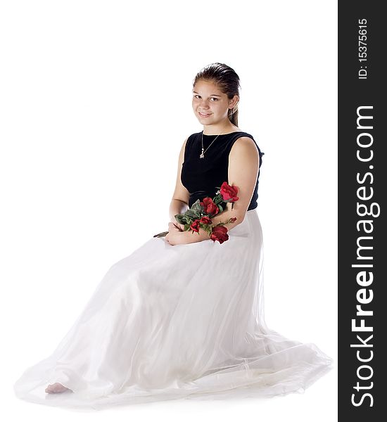 A dressed up young teen sitting with a bouquet of red roses. Isolated on white. A dressed up young teen sitting with a bouquet of red roses. Isolated on white.