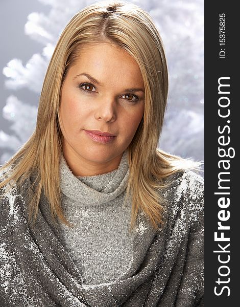 Fashionable Woman Wearing Knitwear In Studio In Front Of Christmas Tree