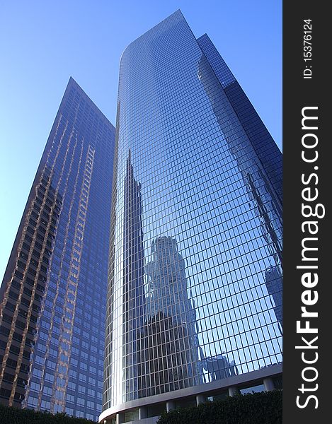 Two tall sky scrapers on a cloudless blue sky. Two tall sky scrapers on a cloudless blue sky