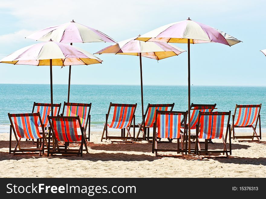 Group of canvas bed and beach umbrellas placing on the Cha-am beach of Thailand. Group of canvas bed and beach umbrellas placing on the Cha-am beach of Thailand