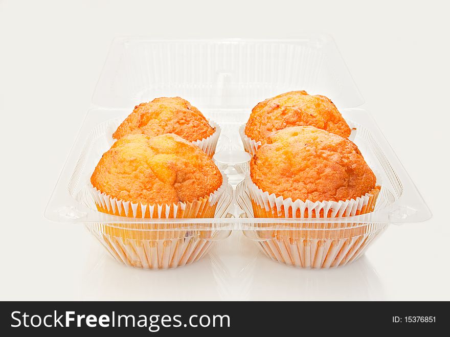 Fresh baked cupcakes in plastic container. Shallow depth of field