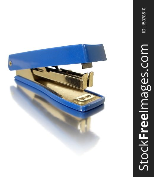 Small blue stapler on white background with reflection effect