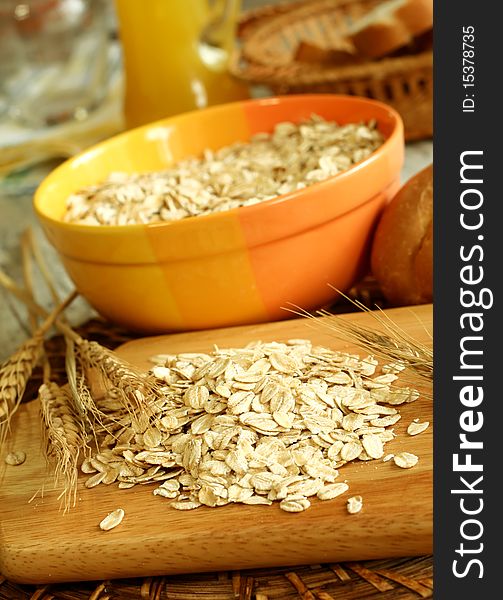 Oats in yellow bowl on a wooden. Oats in yellow bowl on a wooden