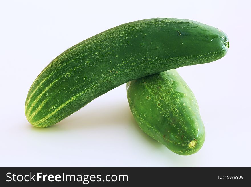 Two green cucumbers on a white background.