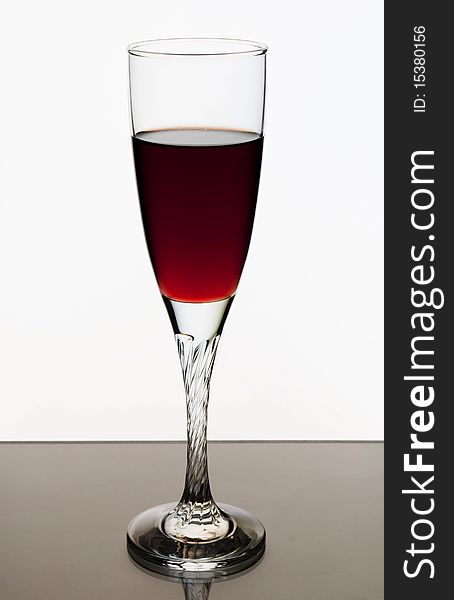 A glass of red wine on a white background. A glass of red wine on a white background.
