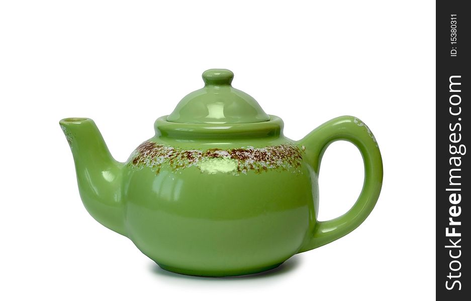 Ceramic teapot of green colour on a white background. It is isolated.