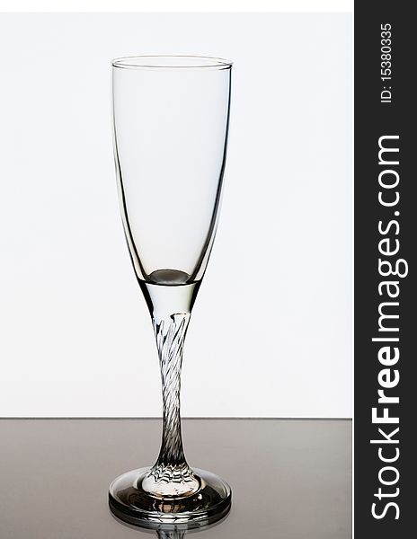 An empty glass on a white background, lighting konrovoe. An empty glass on a white background, lighting konrovoe